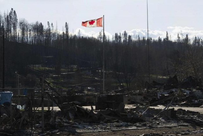 Some evacuation orders lifted in Canada`s scorched oil lands